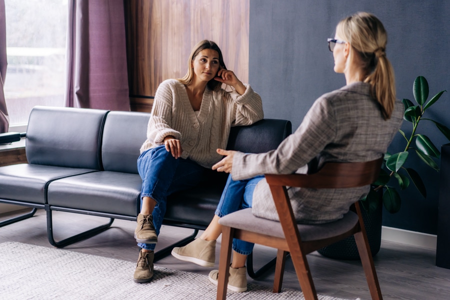 woman speaking to therapist in office